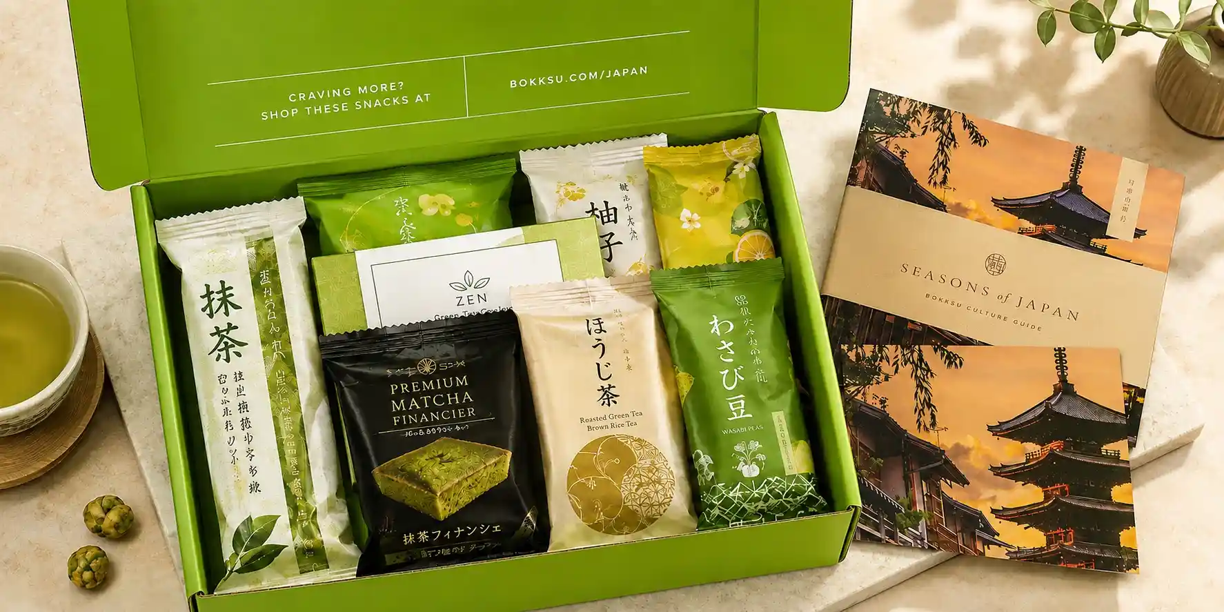 Bokksu Japanese snack subscription box filled with green tea snacks and tea booklet.