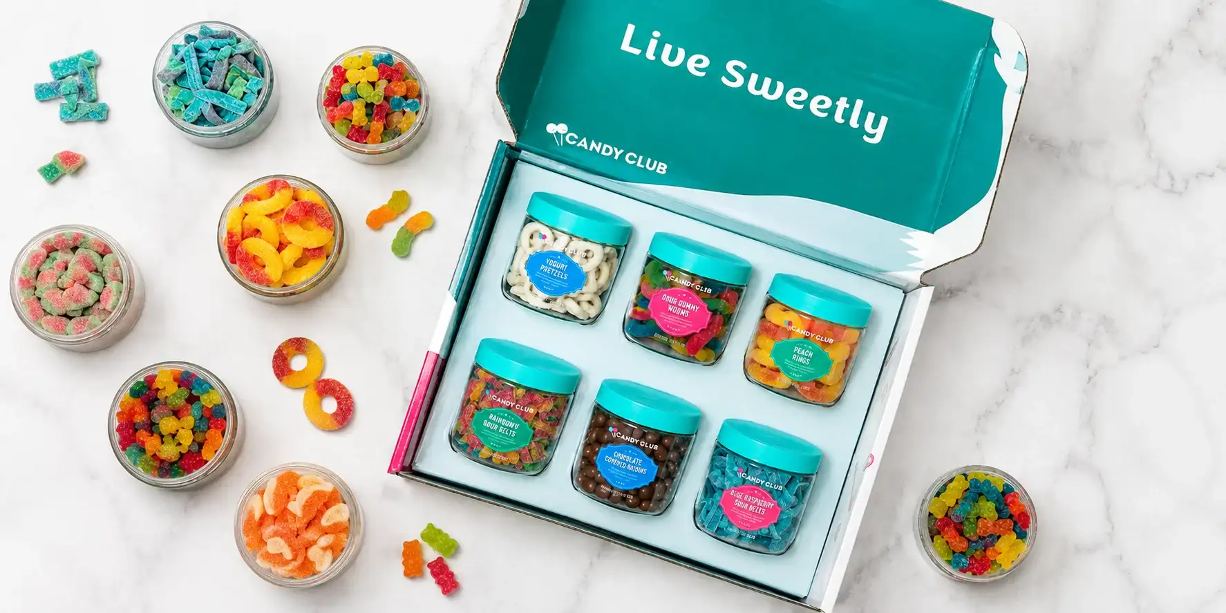 Candy Club subscription box with six clear jars of sweet and sour candies